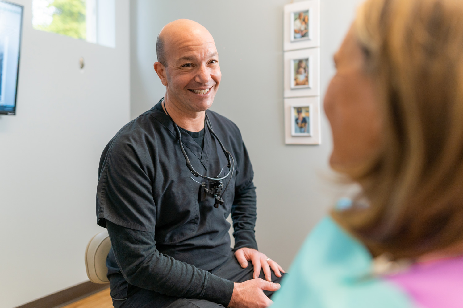 A dentist consulting with a patient about dental implants and dentures, discussing personalized options for smile restoration.