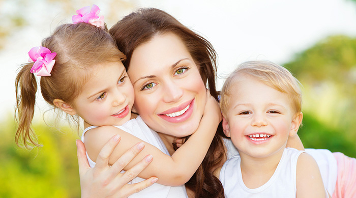 Smiling mother with two kids